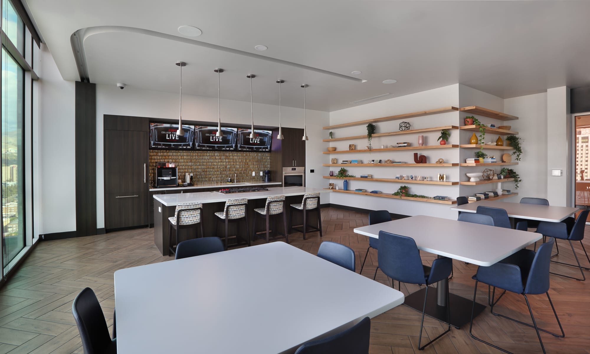 Rooftop clubhouse tables in kitchen with island at Luxury high-rise community of Liberty SKY in Salt Lake City, Utah