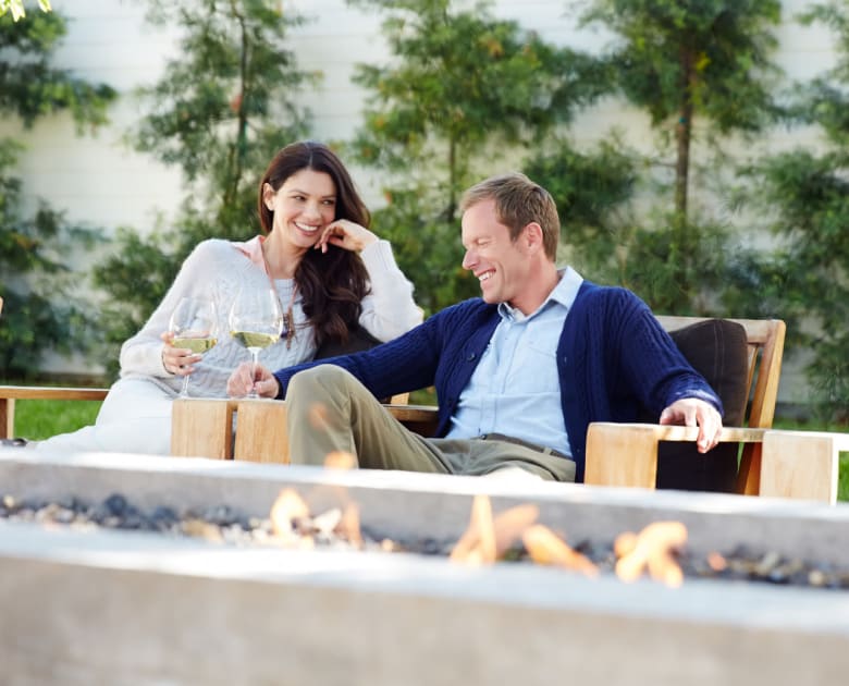 Couple sitting at fire pit at Kelson Row at Rocky Hill in Rocky Hill, Connecticut