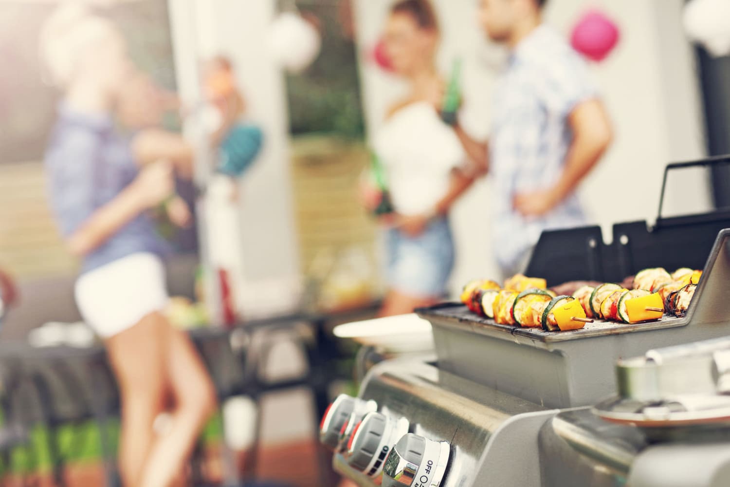 Family grilling on a sunny day at Post Ridge Apartments in Nashville, Tennessee