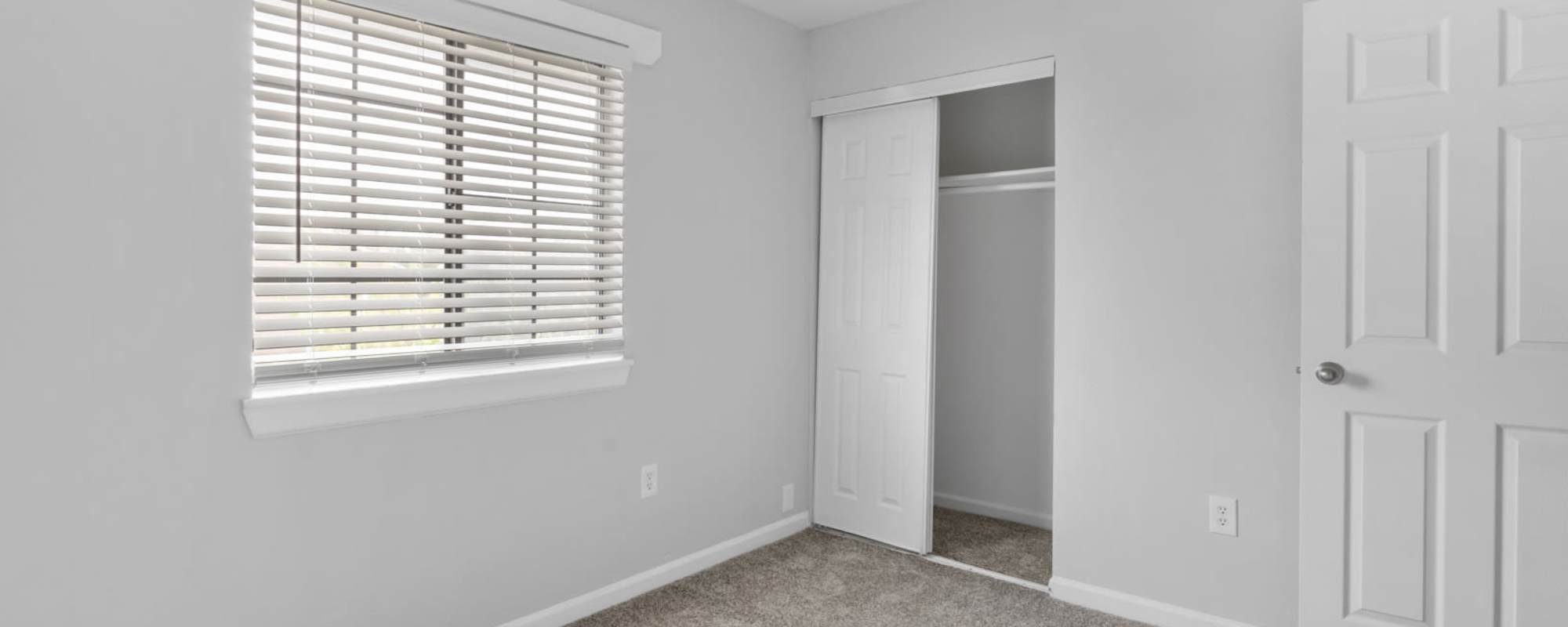 Bedroom with a window and sliding closet doors at Eagle's Edge in Indianapolis 