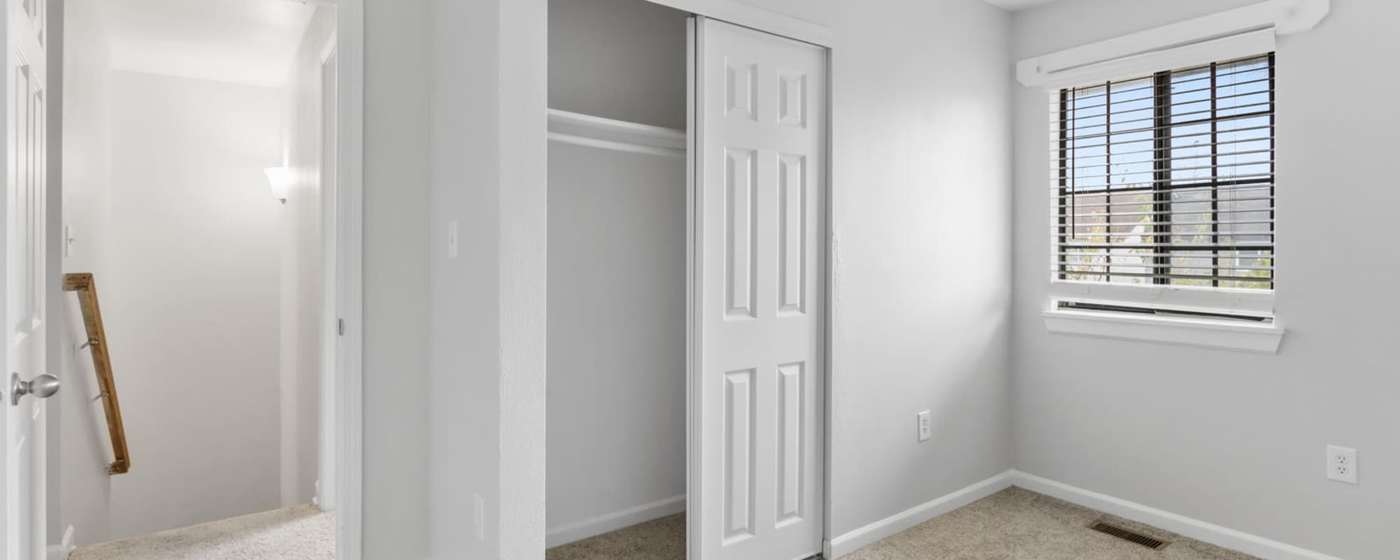 Upstairs bedroom at Eagle's Edge with a window and sliding closet doors