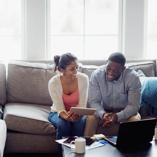 A resident working together in living room at Osprey Point in Virginia Beach, Virginia