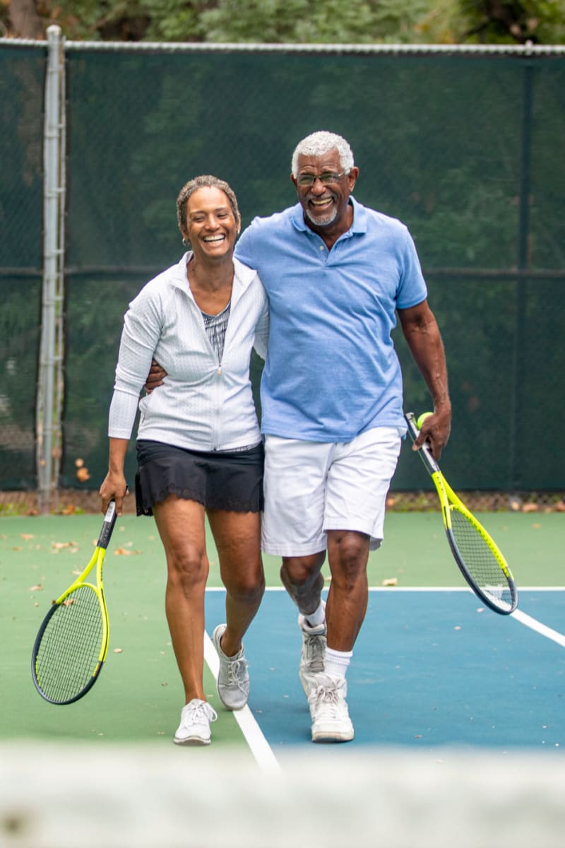 A couple playing tennis at Optima Verdana® in Wilmette, Illinois
