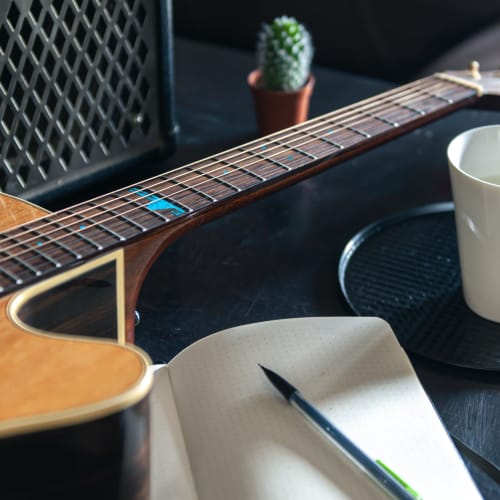 Guitar and notebook sitting on a table at Sherwood in Folsom, California