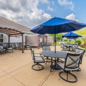 Patio with ample outdoor seating and tables at Schuyler Commons in Utica, New York.
