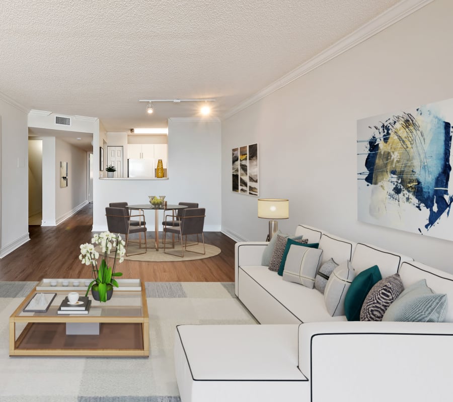 Open concept living room and dining room in a beautiful model apartment home at St. Tropez Apartments in Miami Lakes, Florida