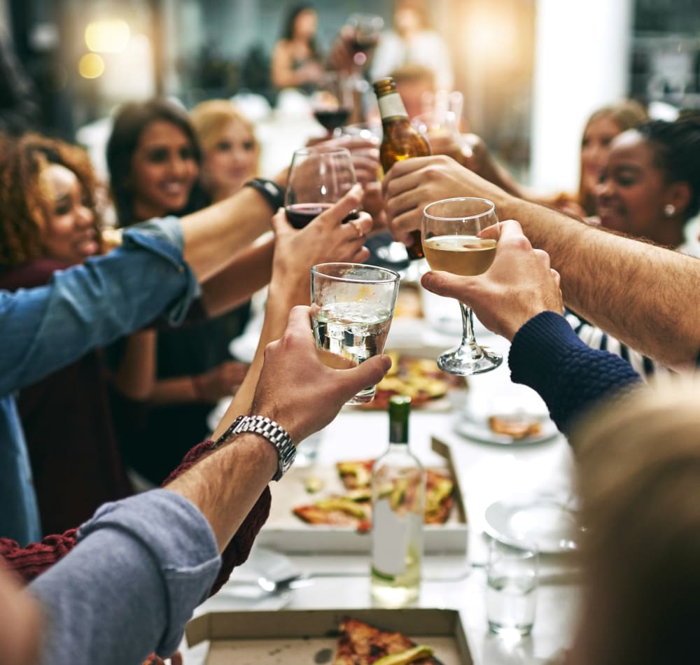 Group of resident friends out for a meal at their favorite restaurant and raising a toast to the good life at Montecito Apartments in Santa Clara, California