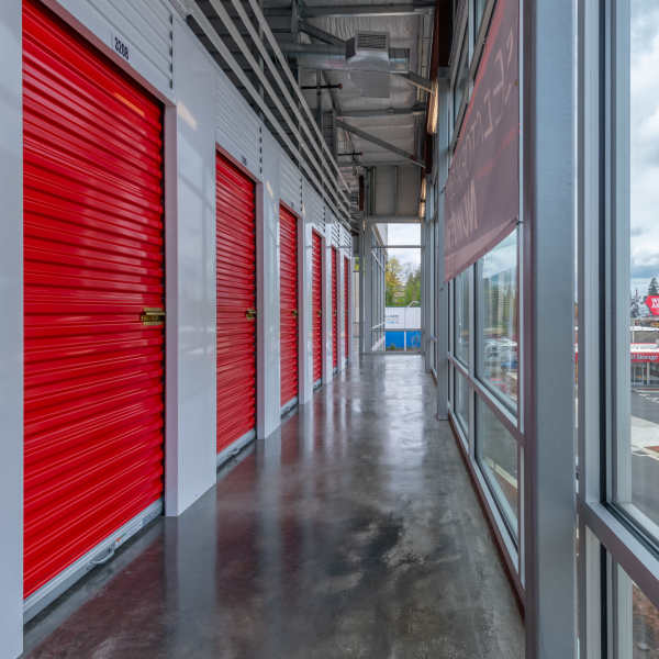 Indoor storage units with red doors at StorQuest Self Storage in Portland, Oregon