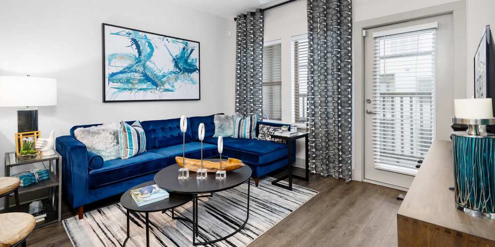 Furnished apartment bedroom with large sunlit window at SoBA Apartments in Jacksonville, Florida