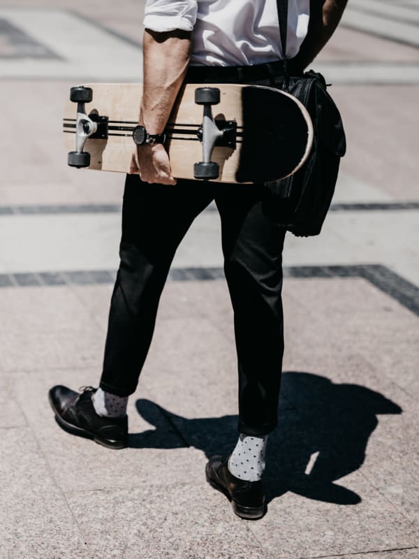 Resident carrying a skateboard in Houston, Texas near Bellrock Summer Street
