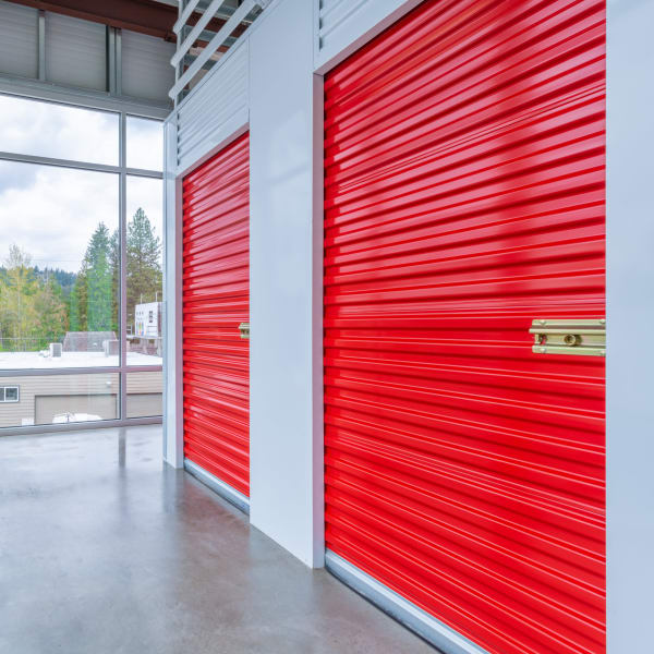 Indoor storage units with red doors at StorQuest Self Storage in Seattle, Washington