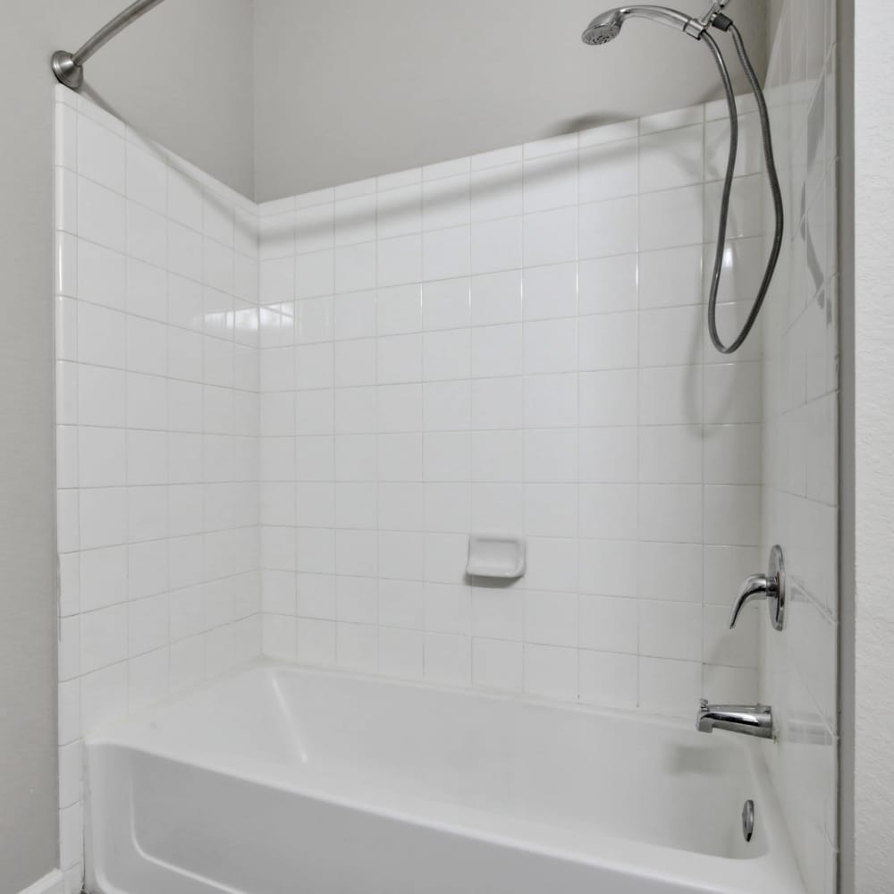 Bathroom with tiled shower and bathtub at Chenal Pointe at the Divide in Little Rock, Arkansas