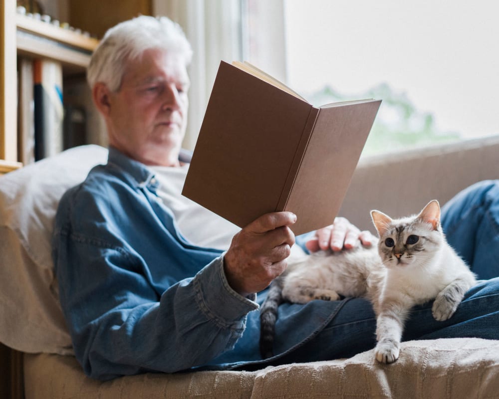 A cat in a man's lap at Waverly Place in Albany, Oregon