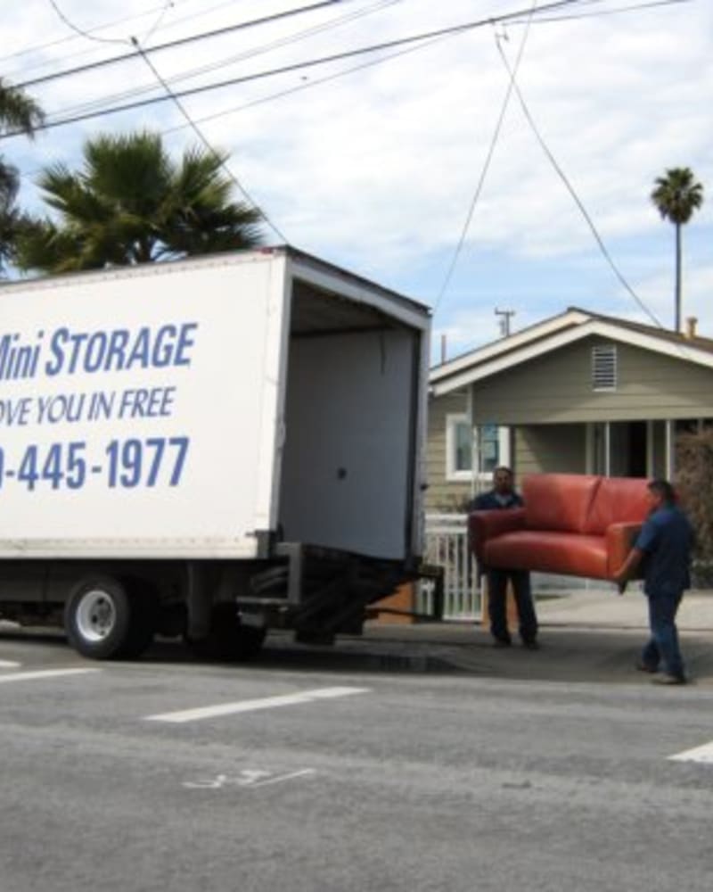 Workers moving packaged boxes at CSI Mini Storage Richmond in Richmond, California