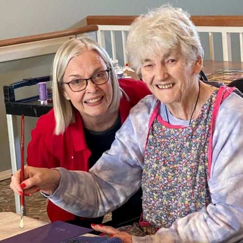 A resident holding a craftwork owl at Canoe Brook Assisted Living & Memory Care in Catoosa, Oklahoma