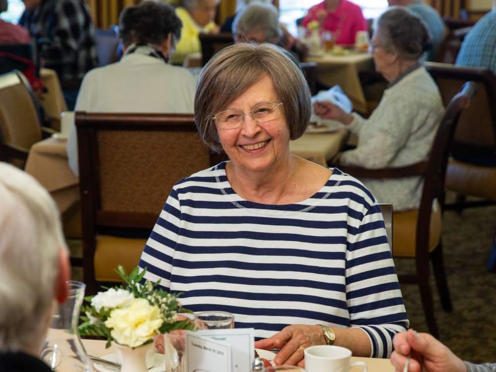 A resident playing cards with fellow residents at Touchmark Central Office in Beaverton, Oregon