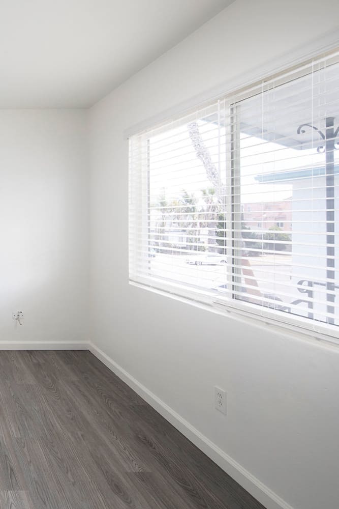 Photo of living room with large windows and vinyl plank flooring 