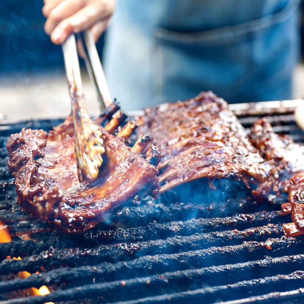 Resident utilizing the grill stations at The Local on Severn in Metairie, Louisiana