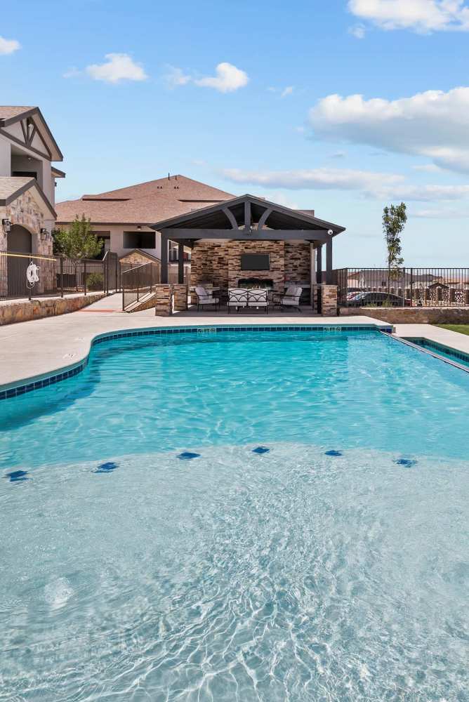 Swimming pool with grill station and community view at Retreat at Horizon Hills in El Paso, Texas