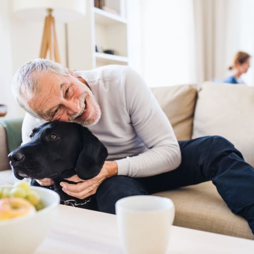 A resident hugging his dog at Castle Acres in Norfolk, Virginia