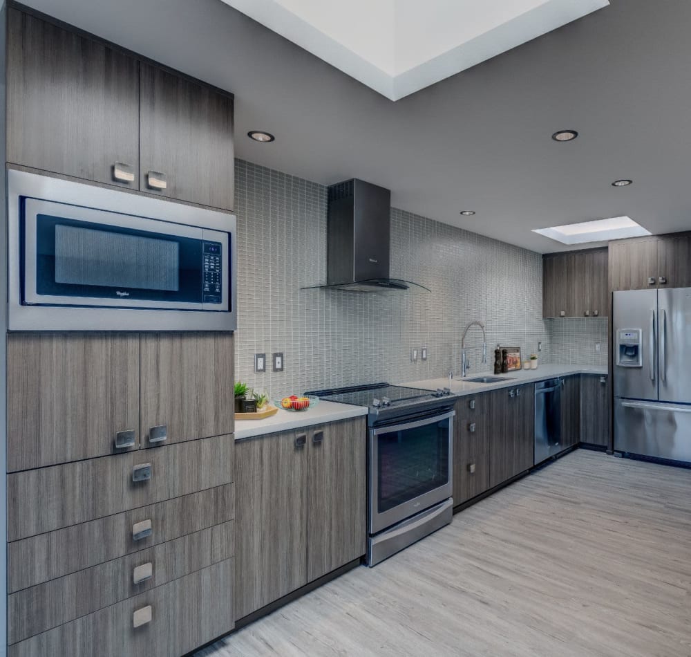 Stainless-steel appliances and an island in a model home's kitchen at Panorama Apartments in Seattle, Washington