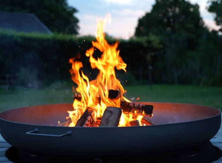 Outdoor fire pit with flames at 71 Westland Apartments in Boston, Massachusetts