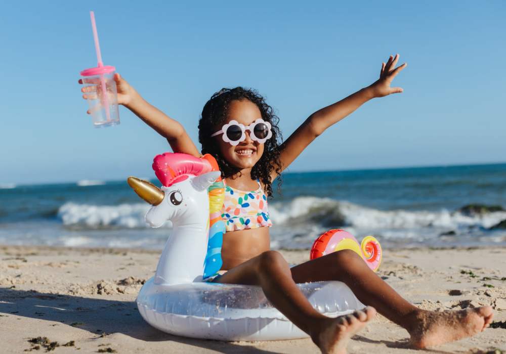Kid playing with her toy by the beach near UCE Apartment Homes in Fullerton, California 