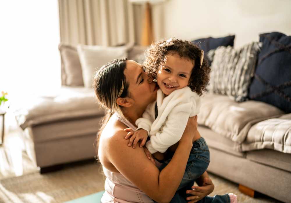 Resident with her daughter in a living room at Heritage Park Apartments & Townhomes in Webster, New York