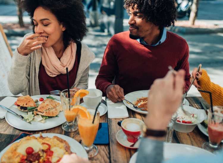 Residents dining outdoors together at 71 Westland Apartments in Boston, Massachusetts