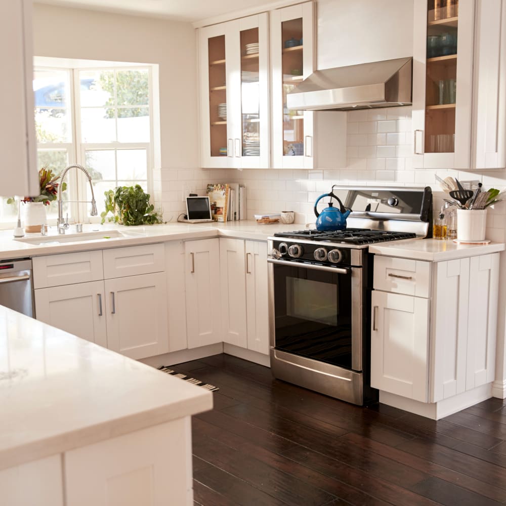 Kitchen with hardwood floors and stainless-steel appliances at Townhomes on Gading in Hayward, California