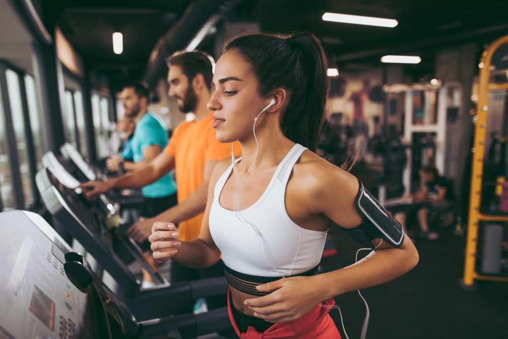 Resident running on the treadmill in the fitness center at Muirwood Apartment Homes in Martinez, California