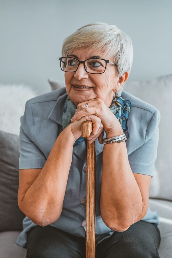 Woman resting her head on her cane at Coeur D'Alene Plaza in Spokane, Washington