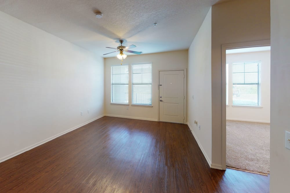 Large windows with a ceiling fan in the living room at The Hawthorne in Jacksonville, Florida