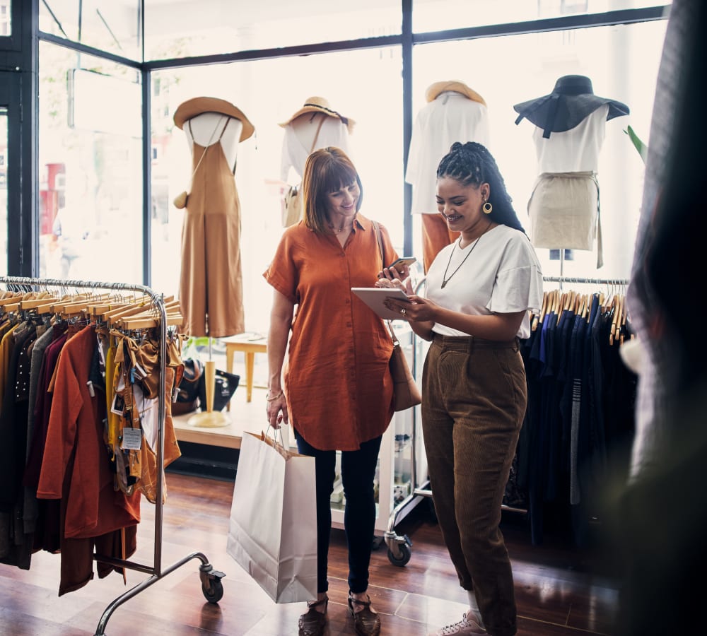 Resident looking through clothes in a shop near Mode at Ballast Point in Tampa, Florida