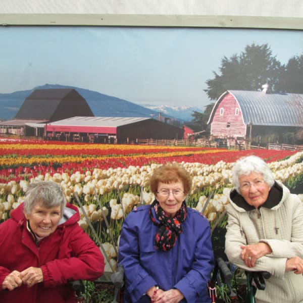 3 women standing in front of a mural of tulips at Quail Park at Morrison Ranch in Gilbert, Arizona