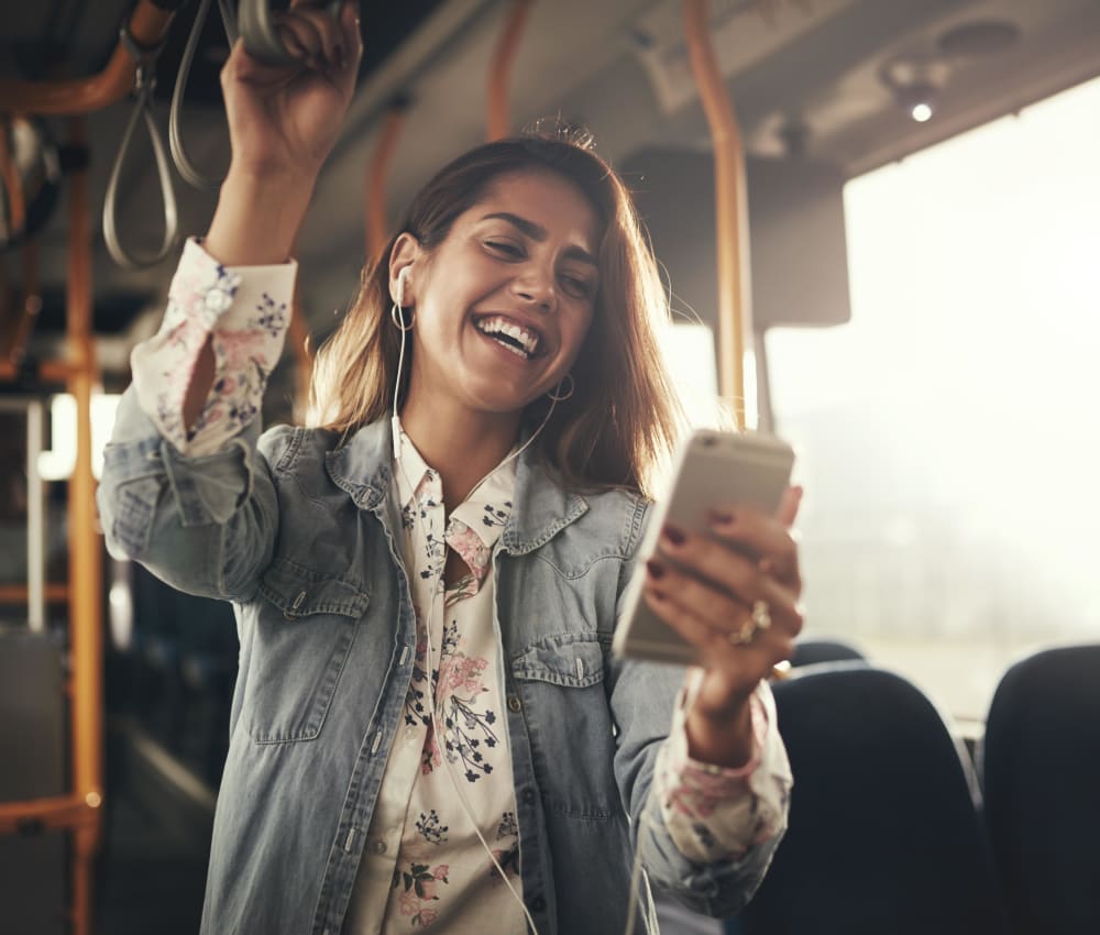 Resident on her phone while taking the bus to work near Alley South Lake Union in Seattle, Washington