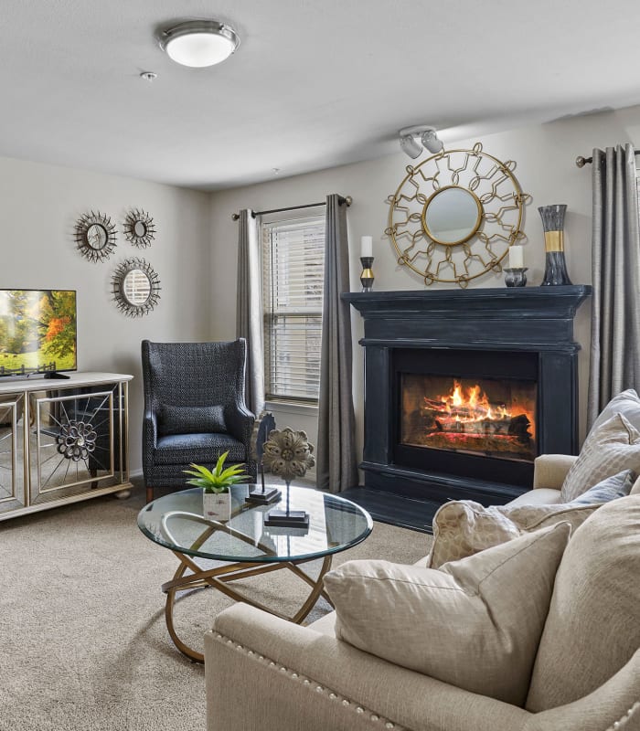 Carpeted living room at Cottages at Abbey Glen Apartments in Lubbock, Texas