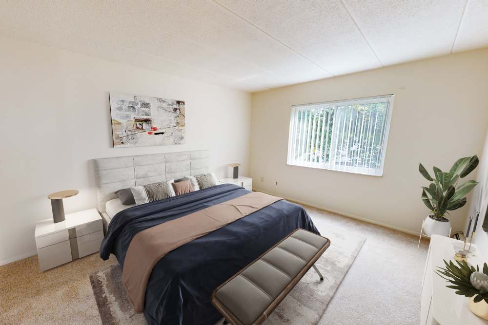 Spacious bedroom with a large window at Vantage Pointe West Apartment Homes in Cincinnati, Ohio
