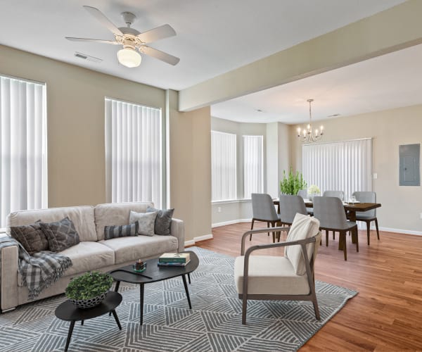 A furnished living room and dining room in a home at The Village at Carolina Meadows in Chesapeake, Virginia