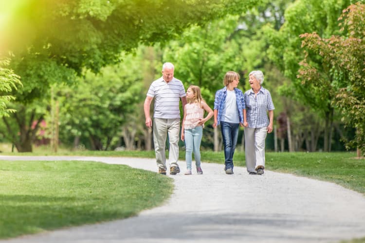 Happy grandparents walking with their grand kids at BPM Senior Living