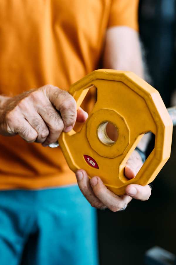 Resident using weights at Merrill Gardens at Green Valley Ranch in Henderson, Nevada