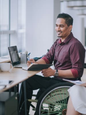 A man on his computer at her job near Radiate in Redmond, Washington