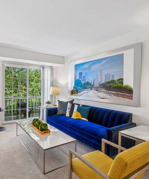 Living room opening onto a private balcony at Saddle Creek Apartments in Novi, Michigan