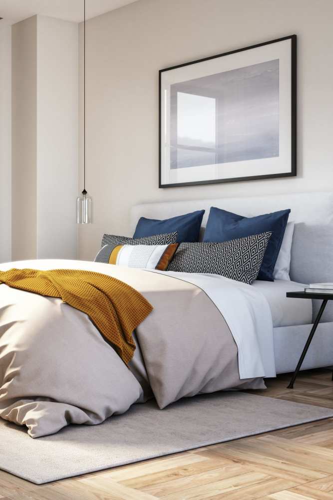 Comfortably furnished primary bedroom in a model apartment at Avalon I Apartments in North Charleston, South Carolina