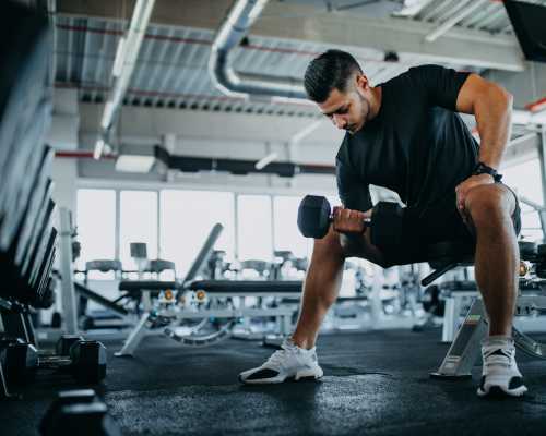Resident lifting dumbbell in fitness center at The Fowler in Boise, Idaho
