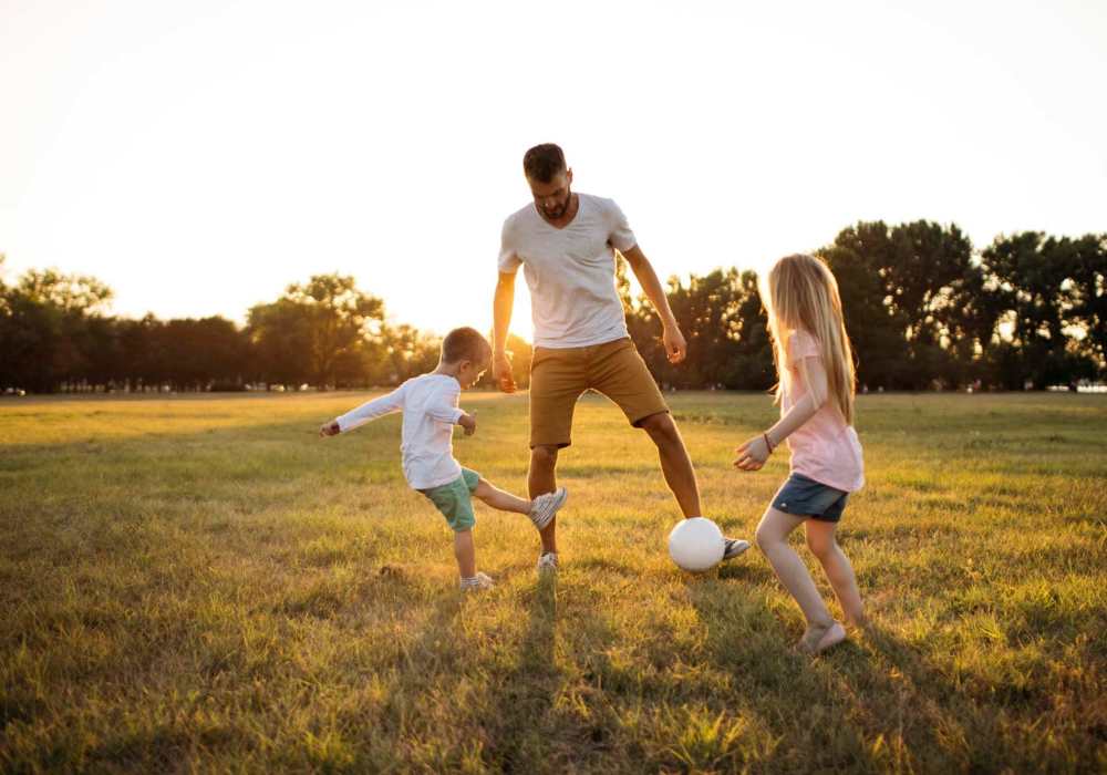 Father and kids playing in outdoor nearby UCE Apartment Homes in Fullerton, California