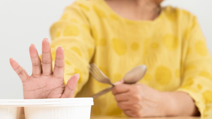 an old woman rejecting her food
