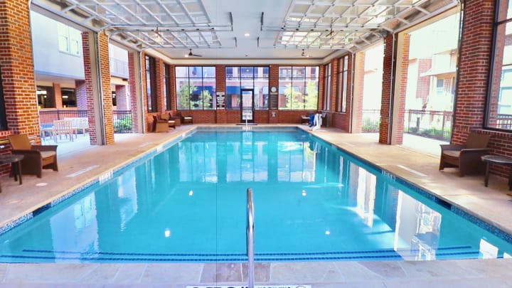 Enjoy year-round relaxation at The Landing at Watermere Frisco’s heated indoor pool. This elegant, light-filled space offers a serene setting for swimming, water aerobics, or simply unwinding in a comfortable lounge area designed for wellness and leisure.