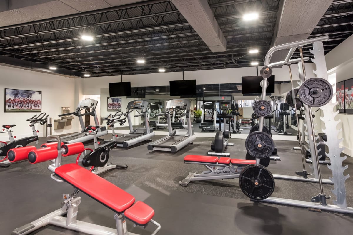 Resident enjoying the modern gym at Fox and Hounds Apartments in Columbus, Ohio