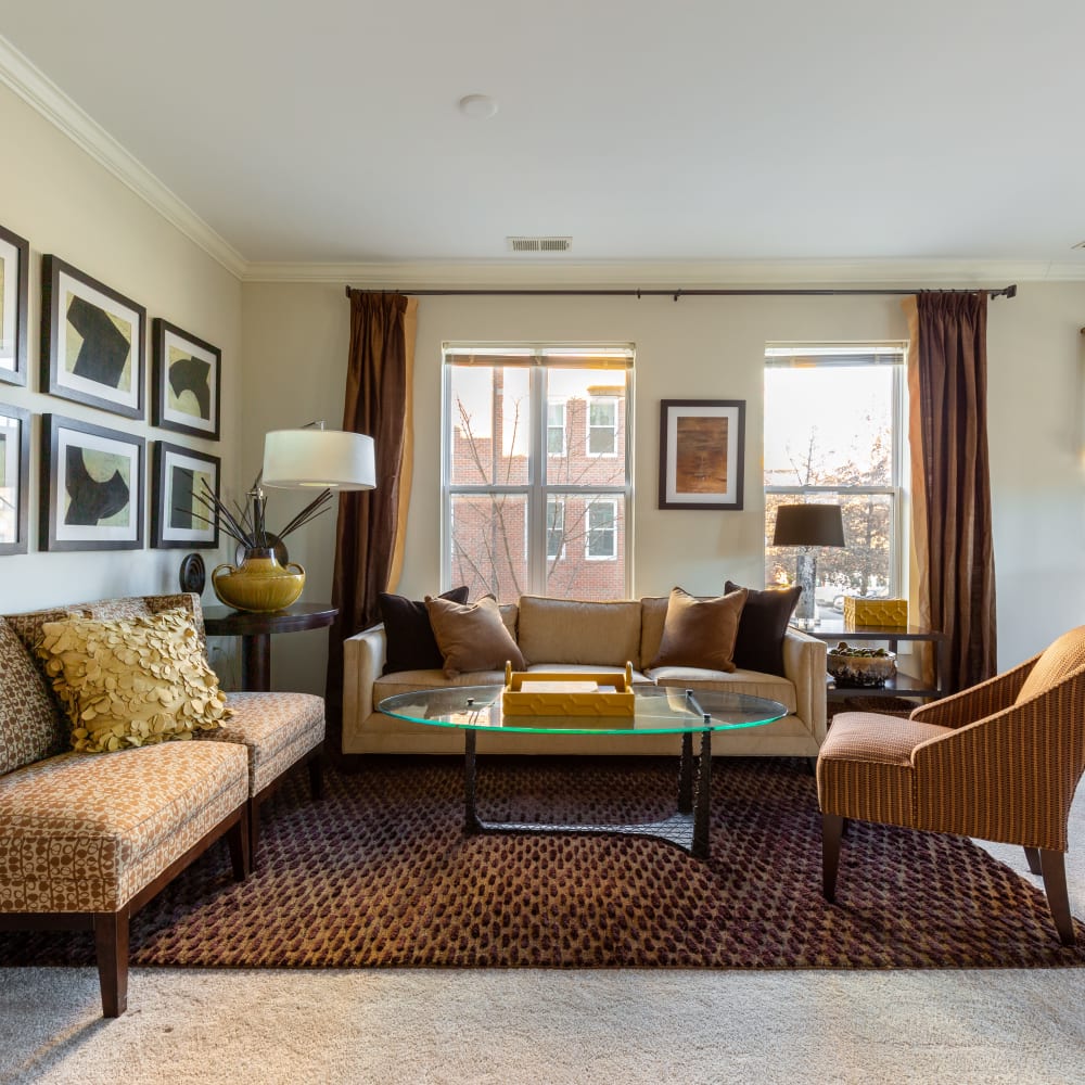 An apartment living room opening to an outdoor patio at Mode at Hyattsville in Hyattsville, Maryland